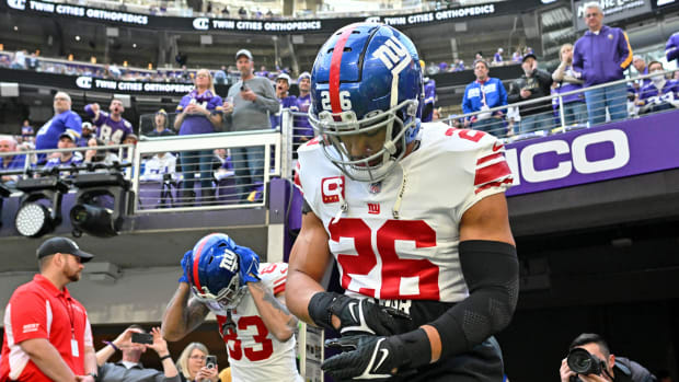 Jan 15, 2023; Minneapolis, Minnesota, USA; New York Giants running back Saquon Barkley (26) runs onto the field before a wild card game against the Minnesota Vikings at U.S. Bank Stadium.